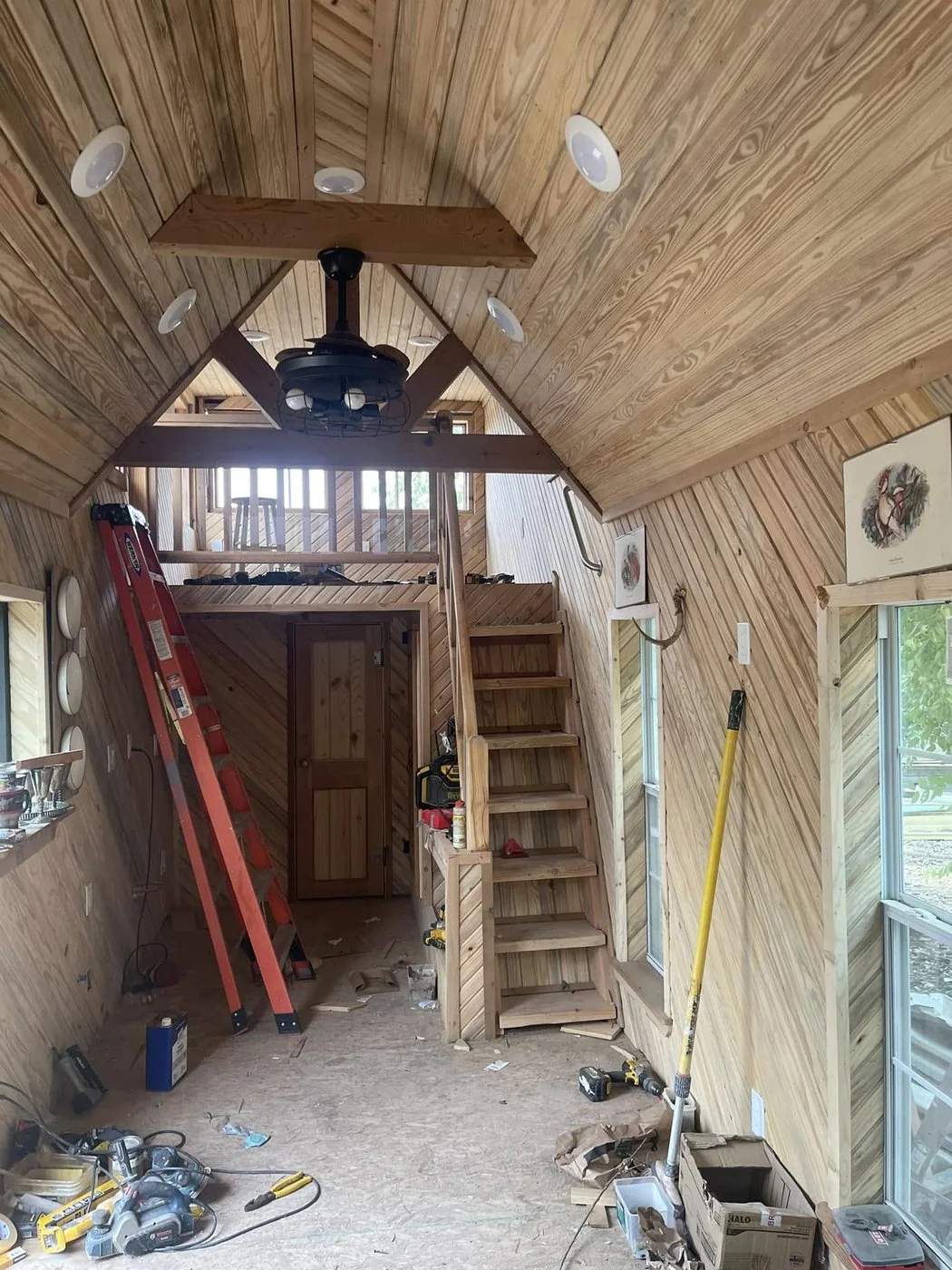 Tiny home interior mid-build, loft ladder in place