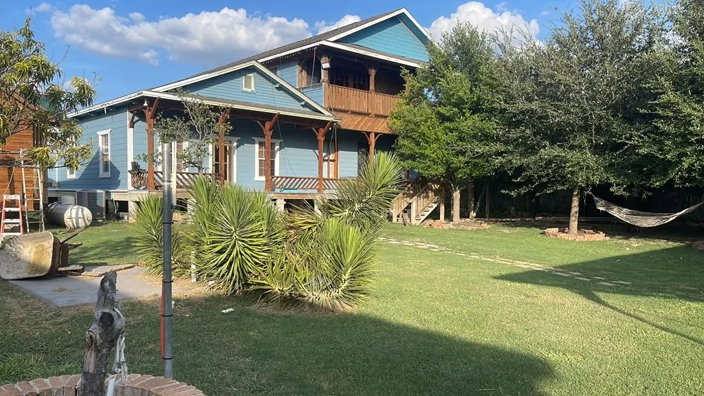 Tiny home set up on a yard with a hammock beside it